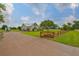 Charming home featuring a long driveway, manicured lawn, and a decorative wooden fence surrounding the property at 3212 E Merrin Rd, Plant City, FL 33567