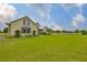 Attractive home featuring well-maintained landscaping, a vibrant green lawn, and charming architectural details at 3212 E Merrin Rd, Plant City, FL 33567
