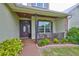 Welcoming front porch with stone accents, charming seating, and a well-maintained garden at 3212 E Merrin Rd, Plant City, FL 33567