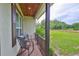 Relaxing front porch with rocking chairs, and peaceful views of the landscaped yard and fenced pasture at 3212 E Merrin Rd, Plant City, FL 33567
