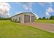 Spacious detached garage with two roll-up doors and ample parking on driveway at 3212 E Merrin Rd, Plant City, FL 33567