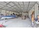 Spacious garage featuring room for boat storage, tools, and lawn equipment at 3212 E Merrin Rd, Plant City, FL 33567