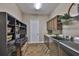 Well-equipped laundry room features cabinetry, shelving, and modern washer/dryer at 3212 E Merrin Rd, Plant City, FL 33567