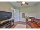 Relaxing media room featuring a large TV, comfortable seating, and neutral decor at 3212 E Merrin Rd, Plant City, FL 33567