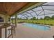 Enjoy the screened-in pool with a bar and outdoor dining area at 3212 E Merrin Rd, Plant City, FL 33567