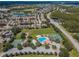 An aerial view of a community featuring a pool, tennis courts, a basketball court, and well-maintained landscaping at 3305 Hoylake Ct, Land O Lakes, FL 34638