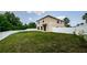 Spacious backyard featuring a well-maintained lawn, white fence, and exterior of the two-story home at 3305 Hoylake Ct, Land O Lakes, FL 34638