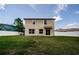 Expansive backyard with the exterior of the house, a white fence, and a green lawn at 3305 Hoylake Ct, Land O Lakes, FL 34638