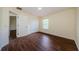Bright bedroom with wood-look flooring, natural light, and a closet offers a cozy retreat at 3305 Hoylake Ct, Land O Lakes, FL 34638