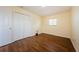 Well-lit bedroom with wood-look flooring, closet, and a window creates a comfortable atmosphere at 3305 Hoylake Ct, Land O Lakes, FL 34638