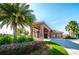 The Ballantrae community clubhouse with palm trees, lush landscaping, and a porte cochere at 3305 Hoylake Ct, Land O Lakes, FL 34638