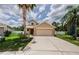 Charming two-story home featuring a well-manicured lawn and a convenient two-car garage at 3305 Hoylake Ct, Land O Lakes, FL 34638