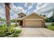 Beautiful home with a two-car garage and stone accents, complemented by a well-maintained lawn and landscaping at 3305 Hoylake Ct, Land O Lakes, FL 34638