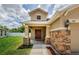 Charming home with a covered front porch, stone accents, and a well-maintained lawn at 3305 Hoylake Ct, Land O Lakes, FL 34638