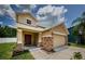 Inviting two-story home featuring a stone-accented facade and a well-manicured lawn at 3305 Hoylake Ct, Land O Lakes, FL 34638