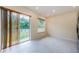 An open-concept living room features lots of natural light from the sliding doors to the backyard at 3305 Hoylake Ct, Land O Lakes, FL 34638