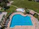 Aerial view of the resort-style pool, splash pad, lounge chairs, and meticulously kept grounds at 3305 Hoylake Ct, Land O Lakes, FL 34638