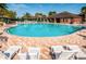 Community pool with lounge chairs, covered seating, and a bar area, perfect for relaxation and entertainment at 3305 Hoylake Ct, Land O Lakes, FL 34638