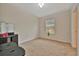 Bright bedroom featuring neutral carpet, a window with blinds, and space for personalization at 3320 Pleasant Willow Ct, Brandon, FL 33511