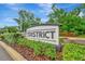 Community welcome sign featuring 'The District' name and manicured landscaping at 3320 Pleasant Willow Ct, Brandon, FL 33511