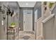 Stylish entryway featuring a gray accent wall, decorative rug, and practical storage solutions at 3320 Pleasant Willow Ct, Brandon, FL 33511
