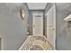 Bright entryway featuring decorative rug, neutral paint, welcome sign and white trim at 3320 Pleasant Willow Ct, Brandon, FL 33511
