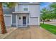 Attractive townhouse boasting a tidy facade, convenient two-car garage, and inviting entrance at 3320 Pleasant Willow Ct, Brandon, FL 33511