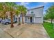 Charming townhouse featuring lush palm trees, a driveway, and an attached two-car garage at 3320 Pleasant Willow Ct, Brandon, FL 33511