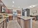 Well-equipped kitchen with stainless appliances, granite counters, island with a sink, and adjacent dining area at 3320 Pleasant Willow Ct, Brandon, FL 33511