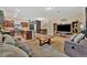 Comfortable living room featuring a large TV, stylish furnishings, and an open view to the kitchen at 3320 Pleasant Willow Ct, Brandon, FL 33511
