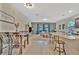 Open-concept living space featuring modern appliances, dining room set, and comfortable furniture at 3320 Pleasant Willow Ct, Brandon, FL 33511