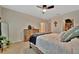 Inviting main bedroom showcasing a ceiling fan, rustic wood furniture, and a doorway to the closet at 3320 Pleasant Willow Ct, Brandon, FL 33511