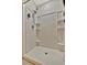 Shower stall with a rainfall shower head, handheld wand, and built-in shelving at 3320 Pleasant Willow Ct, Brandon, FL 33511