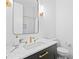 Elegant bathroom with marble countertop, black vanity, and sleek gold fixtures at 334 11Th Ne Ave, St Petersburg, FL 33701