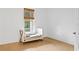 Bright bedroom with wood floors, a crib, and natural light through a window at 334 11Th Ne Ave, St Petersburg, FL 33701