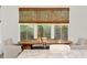 Dining area with wooden table, chairs, bench, and natural light from large windows at 334 11Th Ne Ave, St Petersburg, FL 33701