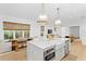 Open-concept kitchen with island, modern lighting, and dining area with natural light at 334 11Th Ne Ave, St Petersburg, FL 33701