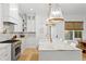Bright kitchen featuring white cabinets, marble countertops, a large island, and pendant lighting at 334 11Th Ne Ave, St Petersburg, FL 33701