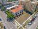 An aerial view of a three-story building boasting multiple balconies, complemented by a parking lot and a vacant grassy lot at 340 1St N St # I, St Petersburg, FL 33701