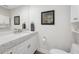 Bright bathroom featuring a white vanity with a gray speckled countertop and framed mirror at 340 1St N St # I, St Petersburg, FL 33701