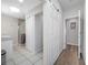 Bathroom showcasing white tiles, a glass shower enclosure, and a barn-style door, blending modern style and functionality at 340 1St N St # I, St Petersburg, FL 33701