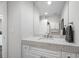 Bathroom featuring granite countertops, a large mirror, and vanity with white cabinets at 340 1St N St # I, St Petersburg, FL 33701