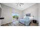 Bedroom with a sliding door to a balcony, ceiling fan, and a framed picture, creating a relaxing retreat at 340 1St N St # I, St Petersburg, FL 33701