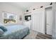 Well-lit bedroom featuring a window, TV, closet, and dresser at 340 1St N St # I, St Petersburg, FL 33701