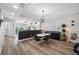 Well-lit dining area featuring a modern light fixture, hardwood floors, and an open connection to the kitchen at 340 1St N St # I, St Petersburg, FL 33701