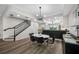 Cozy dining area with a contemporary light fixture, hardwood floors, and a partial view of the staircase at 340 1St N St # I, St Petersburg, FL 33701