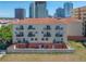 Condo building with a terracotta tile roof and multiple balconies, set against a city skyline backdrop at 340 1St N St # I, St Petersburg, FL 33701