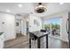 Bright dining area featuring modern lighting fixture, balcony access, and pantry at 340 1St N St # I, St Petersburg, FL 33701