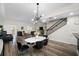 Open concept living room featuring hardwood floors, modern staircase, and stylish furniture at 340 1St N St # I, St Petersburg, FL 33701