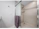 Bathroom with a glass-enclosed shower, modern fixtures, and tile surround, combining style with practical design at 340 1St N St # I, St Petersburg, FL 33701